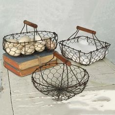 two baskets filled with bread sitting on top of a wooden table next to an open book