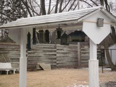 an outhouse in the middle of winter with snow on the ground