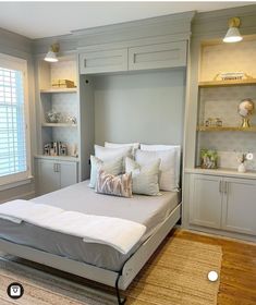 a bed sitting in the middle of a bedroom next to a book shelf filled with books