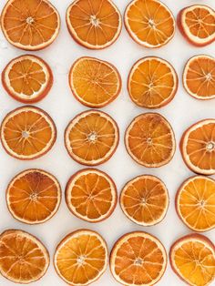 orange slices are arranged in rows on a white surface