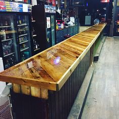 a long wooden counter sitting inside of a store