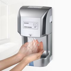 a person is holding their hand out to the water dispenser