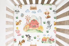 a baby crib with farm animals on it