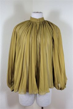 Authenticity guaranteed, older GUCCI mustard green pleated top / blouse Has 7 Gucci buttons, 100% Polyester Made in Italy Size tag says 38 and can fit a Small up to Medium size woman or around sizes 4, 5, 6. Please check the listed measurements below to make sure this will fit you. No returns or exchanges if you purchase and doesn't fit. Measurement below are approximate, taken flat not stretched and all in inches: length (top of shoulder to bottom): 24 in. shoulder across: 14.5 in. chest: 14.5 Chiffon Tops Blouses Classy, Coast Dress, Mustard Green, Chiffon Tops Blouses, Mustard Greens, Pleated Top, Classy Work Outfits, Mesh Long Sleeve, Clothing Ideas