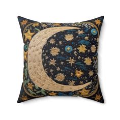 a decorative pillow with the moon and stars on it