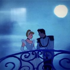 a man and woman standing on top of a balcony next to each other in front of the moon