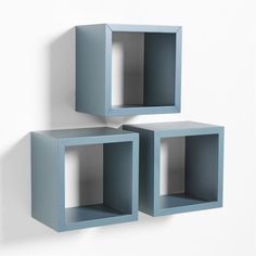 two blue cubes on the wall with one open and one closed, each in different sizes