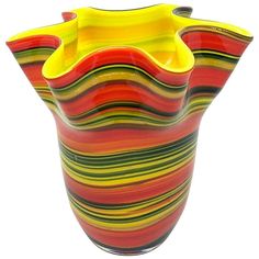 a multicolored vase is shown against a white background