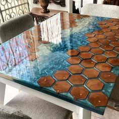 a glass table with wooden tiles on it