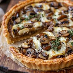 a mushroom and cheese quiche on a cutting board