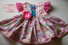 This custom What Girls Dream Of dress has summertime flair and a full skirt for twirling. The versatile style makes it great for summer yet will take you into fall and winter with a few layering pieces. The bodice is fully lined with a coordinating fabric. The trims and fabrics are absolutely gorgeous - a sure showstopper in your little ones wardrobe..   This dress pattern is adapted from the Brownie Goose Lazy Susan & has been "Blake tested" at the park & playground. :)  It is a real-life dress Whimsical Pink Twirl Dress For Spring, Pink Ruffle Twirl Dress For Garden Party, Pink Ruffled Twirl Dress For Garden Party, Pink Twirl Dress With Ruffles For Garden Party, Whimsical Pink Twirl Dress For Playtime, Fitted Whimsical Twirl Dress For Summer, Whimsical Fitted Twirl Dress For Summer, Spring Unicorn Print Dress-up Dresses, Fun Multicolor Twirl Dress With Ruffles