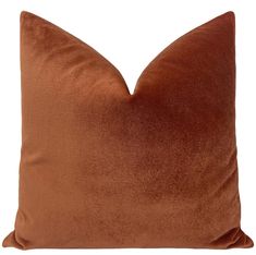 a brown velvet pillow on a white background