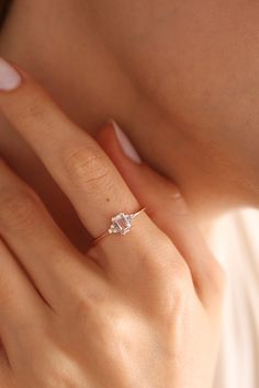 a woman's hand with a diamond ring on her finger