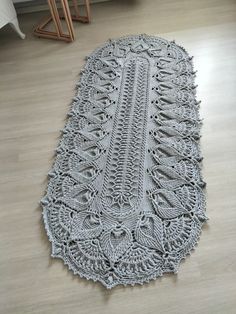 a crocheted table runner on the floor