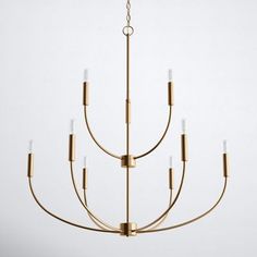 a gold chandelier with six lights hanging from the ceiling