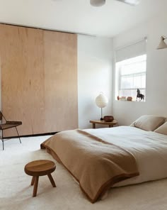 a bedroom with white carpet and wooden walls