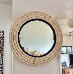 a round rope mirror hanging on the wall