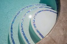 three white plates sitting on top of a swimming pool