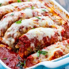 a casserole dish with meat covered in sauce and parmesan cheese on top