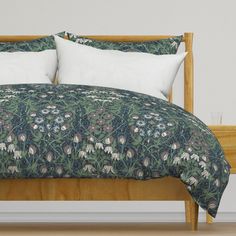 a bed with white pillows and green bedspread