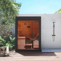 an outdoor sauna is shown with the door open