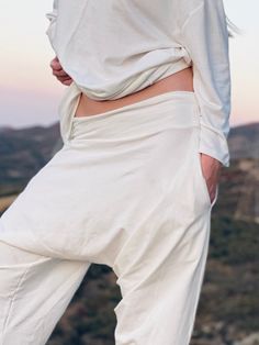 "White Stretch Cotton Harem Pants. -unisex -made in USA -kundalini yoga style -Flowing relaxed fit -2 side pockets Great for Yoga, Dance, Exercises, Meditations, Kundalini Yoga Practice and beyond... \"Feel good, do good, and be good. These are the only goods you can carry along with you; the rest belong to the planet Earth.\" ~Yogi Bhajan. This is our original \"Ceremonial White. Light\" pant from \"Wearing White for Kundalini Yoga\" collection. This piece is a conscious creation with pure beau White Stretch Harem Pants For Yoga, White Harem Pants With Pockets For Loungewear, Cotton Wide-leg Athleisure Harem Pants, Cotton Wide Leg Harem Pants For Athleisure, Comfortable Loosely-fitted Yoga Sweatpants, Comfortable Loose-fit Sweatpants For Yoga, Comfortable Sweatpants With Loosely Fitted Hips For Yoga, Comfortable Yoga Pants With Loosely Fitted Hips For Relaxation, Relaxed Fit Harem Pants For Relaxation