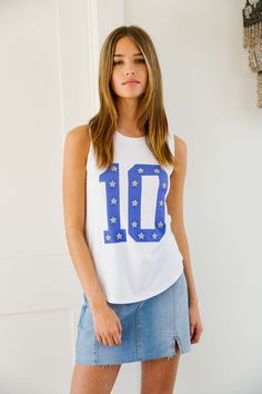 Have fun and stand out with CUSTOM NUMBER TOPS. Choose a white jersey, tee, or tank and personalize it with your own number and silver star patches. Show off your unique style on the field or off. (Winning attitude not included!) All orders are currently shipping within 14 business days. To receive item quicker, expedited shipping is available at checkout. Sporty White T-shirt With Number Print, Collegiate Tops With Number Print For Game Day, Sporty White Tops With Number Print, Sporty White Top With Number Print, White Number Print Sports T-shirt, White T-shirt With Team Name For Summer, Casual White Tank Top For Game Day, Collegiate Number Print Tops For Sports Season, Collegiate White Tops With Number Print