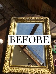 a mirror sitting on top of a wooden table next to scissors and other crafting supplies