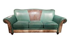 a green leather couch with studded trimmings and nail polishing on it