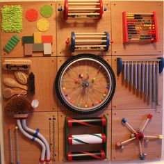 an assortment of toys arranged on top of a wooden paneled wall with pegs