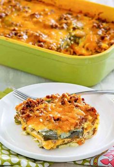 a casserole dish on a plate with a fork next to the casserole