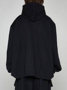 Random Identities' unisex black cotton hoodie featuring a fixed hood, elongated cut-out on front, wide sleeves with puffed cuffs and rounded hem on the back. Composition: 100% cotton Casual Oversized Sweatshirt With Detachable Hood, Oversized Fall Hoodie With Detachable Hood, Oversized Winter Sweatshirt With Detachable Hood, Oversized Hoodie With Ribbed Cuffs And Funnel Neck, Oversized Outerwear With Adjustable Hood And Funnel Neck, Oversized Funnel Neck Outerwear For Streetwear, Oversized Funnel Neck Hoodie For Streetwear, Black Oversized Hoodie With Funnel Neck, Oversized Hooded Jacket With Detachable Hood