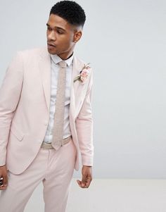 a man in a pink suit and white shirt