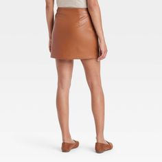 Transform any look into an on-trend statement of bold and edgy style with this Faux-Leather Mini Fashion Skirt from A New Day™. This classic-rise skirt is tailored in a regular fit with a flattering mini-length silhouette. It sports a side zipper closure and skimming darts on the back, along with welt pockets on the front for functional aesthetic. Plus, the fashion skirt is made of extra-lightweight faux leather with full lining and is machine washable for added convenience. A New Day™: Style th Brown Faux Leather Mini Skirt For Party, Party Faux Leather Brown Mini Skirt, Brown Faux Leather Mini Skirt For Fall, Fall Faux Leather Brown Mini Skirt, Casual Faux Leather Mini Skirt For Fall, Chic Spring Faux Leather Pencil Skirt, Casual Faux Leather Skirt For Fall, Chic Fall Mini Pencil Skirt, Chic Fall Pencil Mini Skirt