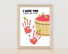 a framed print with an apple basket and handprints on the bottom that says i love you