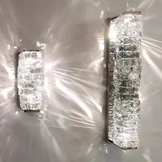 two crystal wall lights mounted to the side of a wall