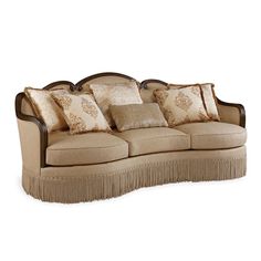 a couch with pillows and fringe trim around the armrests on top of it