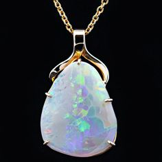 A stunning Australian fossil opal necklace handcrafted in 9ct yellow gold. White opals often display all colours in the spectrum, and this opal is no exception with remarkable neon flashes of colour at every angle. All of our opals are natural solid opals, sustainably and ethically mined in Australia. This pendant has been handcrafted to suit the individual opal, making it a truly unique and one-of-a-kind piece. Necklace comes carefully packaged in a beautiful sustainable timber gift box. The perfect box for the perfect necklace, handcrafted inside and out. Choose from a 45cm or 50cm 9ct gold cable link chain necklace or purchase the pendant only. To customize with a different metal, chain style, or other modification, please contact us for a quote. Luna | Australian Fossil Opal Necklace M Australian Opal Jewelry, Opal Pendant Necklace, Sustainable Jewelry, Opal Crystal, Australian Opal, Black Opal, Opal Pendants, Beach Jewelry, Opal Necklace