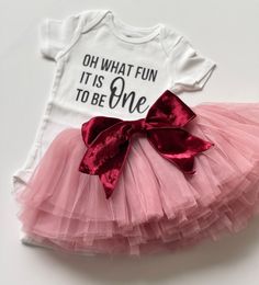 Oh, what fun it is to be one birthday-themed outfit is perfect for Christmas birthdays. This outfit can be custom for a toddler's birthday. This full tutu has 10 full layers with a wide elastic band inside to keep the itchy tulle off your little ones' skin. The soft multiple layers give a full look but lays perfectly. The bow is able to clip onto the tutu or be removed for your desired look. Bow could also be used to clip into your little ones' hair. OPTIONS AVAILABLE FOR PURCHASE: Bodysuit Tutu First Birthday Shirt Girl, Pink Christmas First Birthday, Cute Fitted Tutu Dress For Birthday, Pink Cotton Tutu Dress For Parties, Fun White Tutu Dress For Birthday, Fun Tulle Tutu Dress For Birthdays, White Fun Tutu Dress For Party, Cute Pink Tutu Dress For Christmas, Cute Red Tutu Dress For Birthday