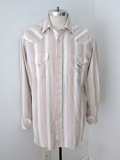 Vtg 80s Miller Beige White Stripe Oxford Cotton Western Shirt Pearl Snaps L Vintage 1980's beige, white and red striped western shirt from Miller. Lightweight, feels like 100% cotton oxford cloth. Features  - pearl snaps - three snap cuffs - chest pockets with snap flaps -  U-hem APPROXIMATE MEASUREMENTS in inches - lying flat Size:  16.5 - 35 (Large) Shoulder to shoulder:   18 Sleeve length, from shoulder:  25 Chest, armpit to armpit:  23 Waist:  21 Length, from top of collar:  33 CONDITION: Go Vintage White Tops With Striped Collar, 80s Striped Shirt, Vintage Striped Shirt With Buttons, Vintage Striped Collared Tops, Vintage Pearl Snap Shirts, Western Shirts, White Stripe, Oxford, Sleeve Length