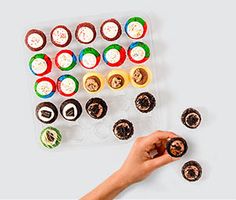 a person is placing cupcakes on top of each other