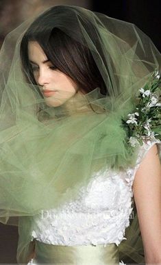 a woman wearing a veil with flowers on it