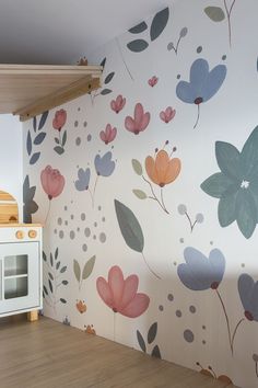 a child's play room with floral wallpaper