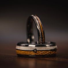 two wedding rings with an arrow on them