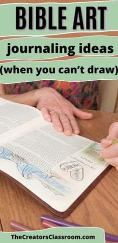 the bible art journal is open on a table with two hands holding an open book