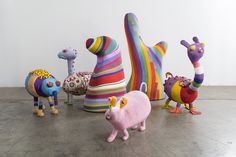 an assortment of colorfully painted stuffed animals