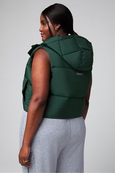 Essential Cropped Hooded Puffer Vest Fabletics green female Activewear >> Womens >> Jackets & Outerwear >> Jackets plus Everyday Hidden Pockets/Reflective/Water-Resistant Fitted Green Winter Activewear, Fitted Green Activewear For Winter, Green Winter Sportswear Activewear, Winter Green Athleisure Activewear, Green Sporty Puffer Jacket For Streetwear, Green Winter Activewear With Drawstring Hood, Green Winter Sports Activewear, Sporty Green Activewear For Winter, Green Sporty Puffer Jacket For Cold Weather