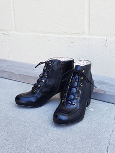 1940's Inspired Lace-Up Work Boot. Proud To Be 100% Vegan Friendly Upper Material: Faux Textured Leather Lining Material: Man Made + Fabric Shaft Height: Measurements From Back Counter Where Heel Starts To Top Of Shaft (based on a size 6 shaft) 4 1/8" Inches Approximate Heel Height: 2 3/8" Inches Step In / Lace Up Front / Inside Zipper Fit: True To Size / If You Take A Wider Width Please Size Up 1/2 For Most Comfortable Fit.Please Contact Customer Care For Any Sizing Suggestions or Questions.Imp Fitted Vintage Black Boots, Vintage Black Workwear Boots, Vintage Low Heel Fitted Boots, Vintage Low Heel Winter Boots, Vintage Fitted Low Heel Boots, Vintage Fitted Boots With Low Heel, Vintage Black Pointed Toe Boots, Retro Fitted Boots For Formal Occasions, Vintage Winter Workwear Boots