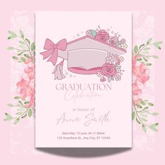 a pink graduation card with flowers and a mortar cap on the top, in front of a