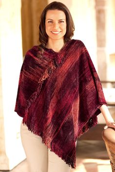 The red undertones of this poncho are inspired by the traditional costumes of San Juan de la Laguna say the women of K'amolon K'i K'ojonel who boast their pride in their classic weaving techniques. Working on a back strap loom the design of this poncho is at once classic and contemporary. A rich blend of cotton and bamboo chenille assures the soft warmth of this trendy poncho. Since the threads are dyed by the women please expect slight differences in the color tone and arrangement. Traditional Red Poncho For Fall, Traditional Red Fall Poncho, Red One-size Poncho Cape, Red One-size Cape Poncho, Red One Size Cape Poncho, Traditional Red One-size Poncho, Traditional Red Shawl Poncho, Crochet Cape, Hairpin Lace